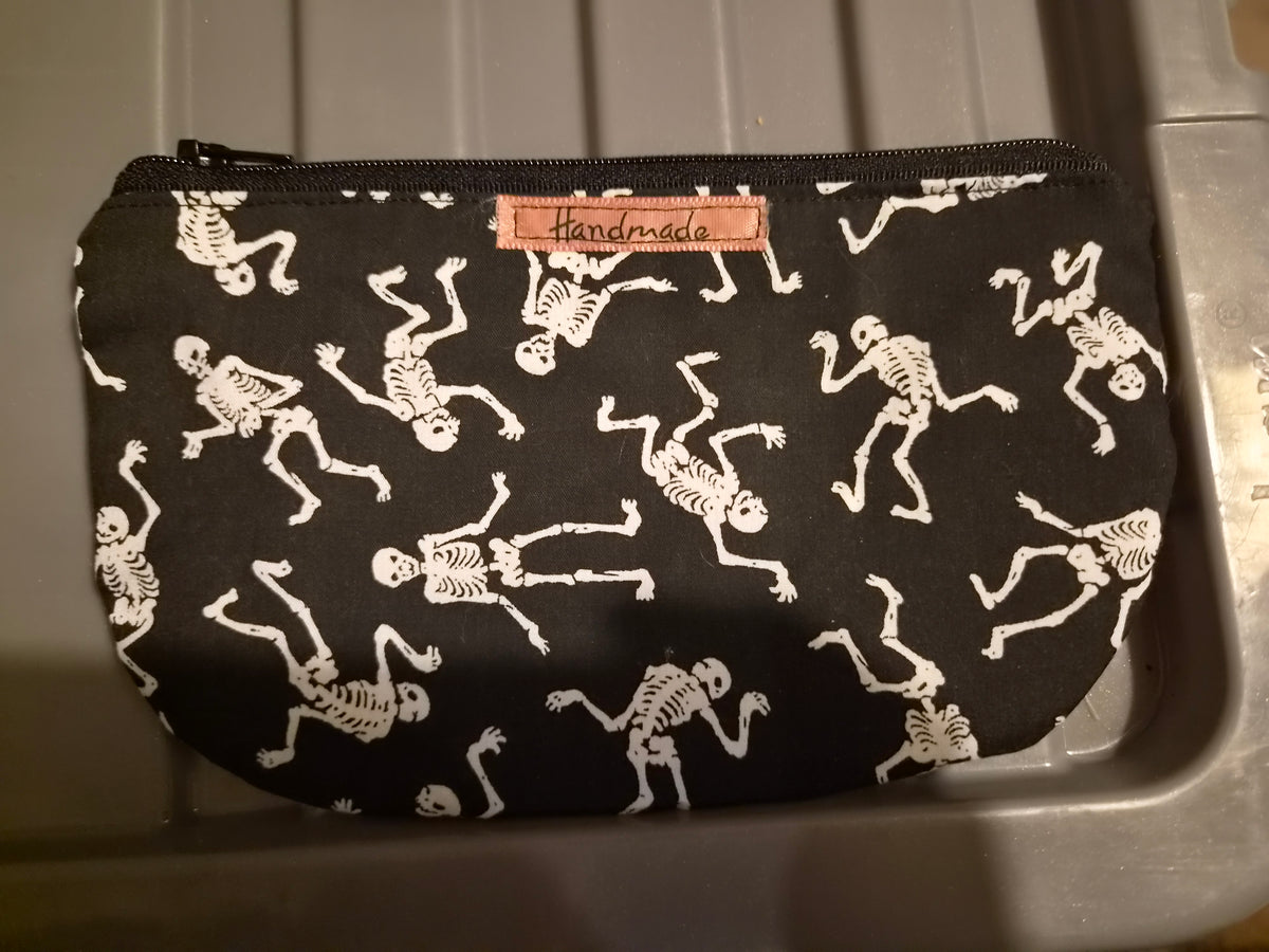 Handmade black makeup bag with white dancing skeletons pattern