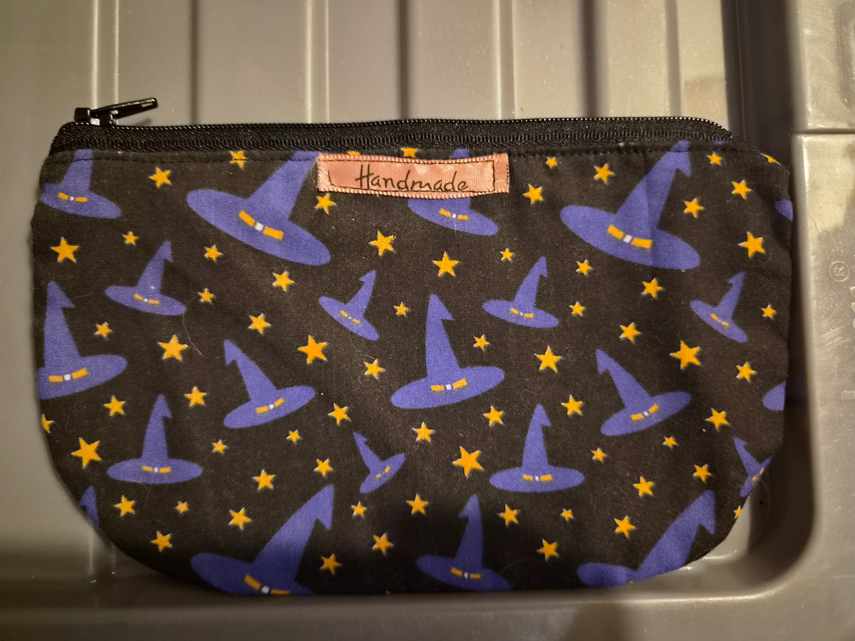 Handmade black makeup bag with purple witch hats and gold stars pattern
