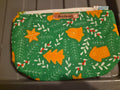 Handmade green makeup bag with golden Christmas cookie shapes and mistletoe pattern