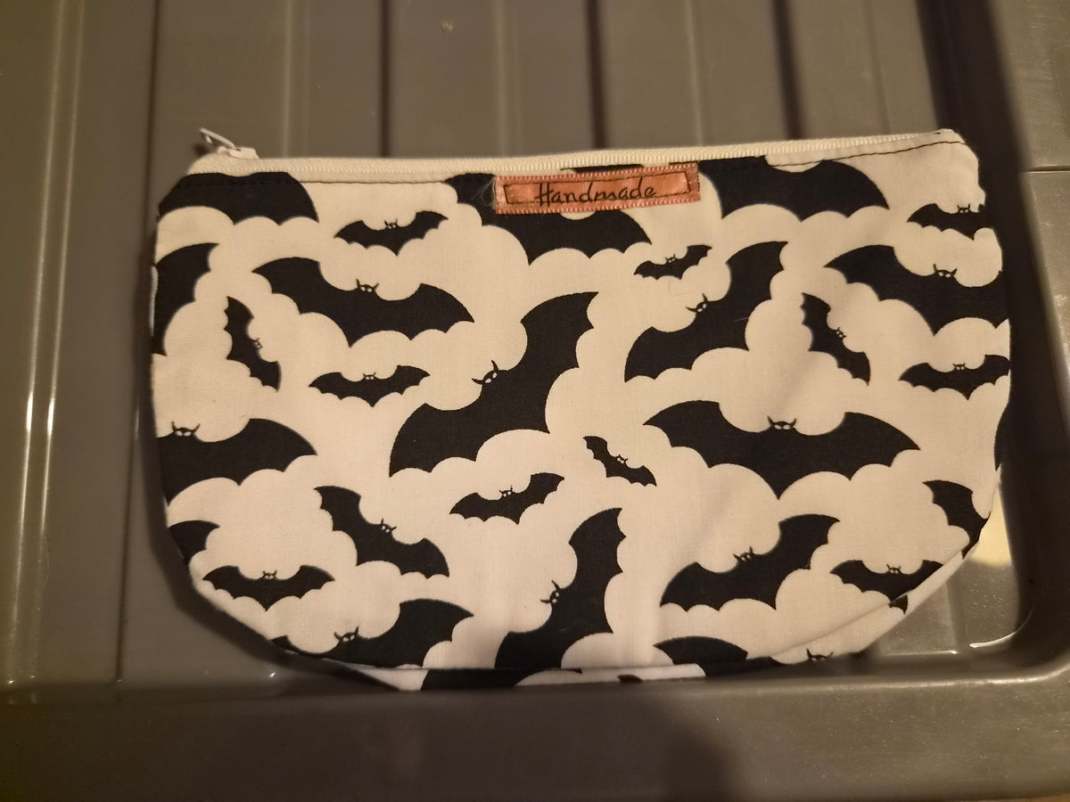 Handmade makeup bag with black bats on white fabric pattern