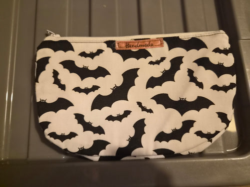 Handmade makeup bag with black bats on white fabric pattern