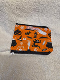 Handmade zip purse with Halloween icons print on orange fabric